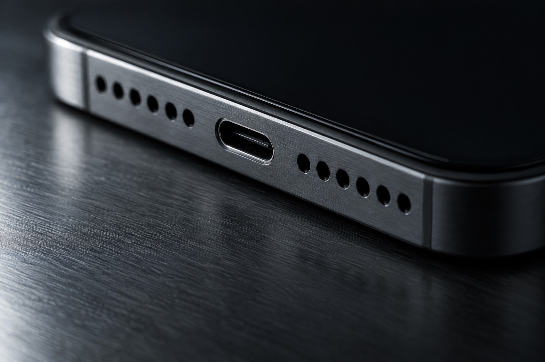 Close view of the lower edge of a phone, port and speaker holes